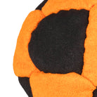 Orange and black hacky sack close up stitching