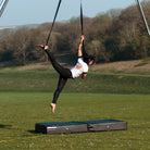 all-groups performer on firetoys aerial straps wearing black and white