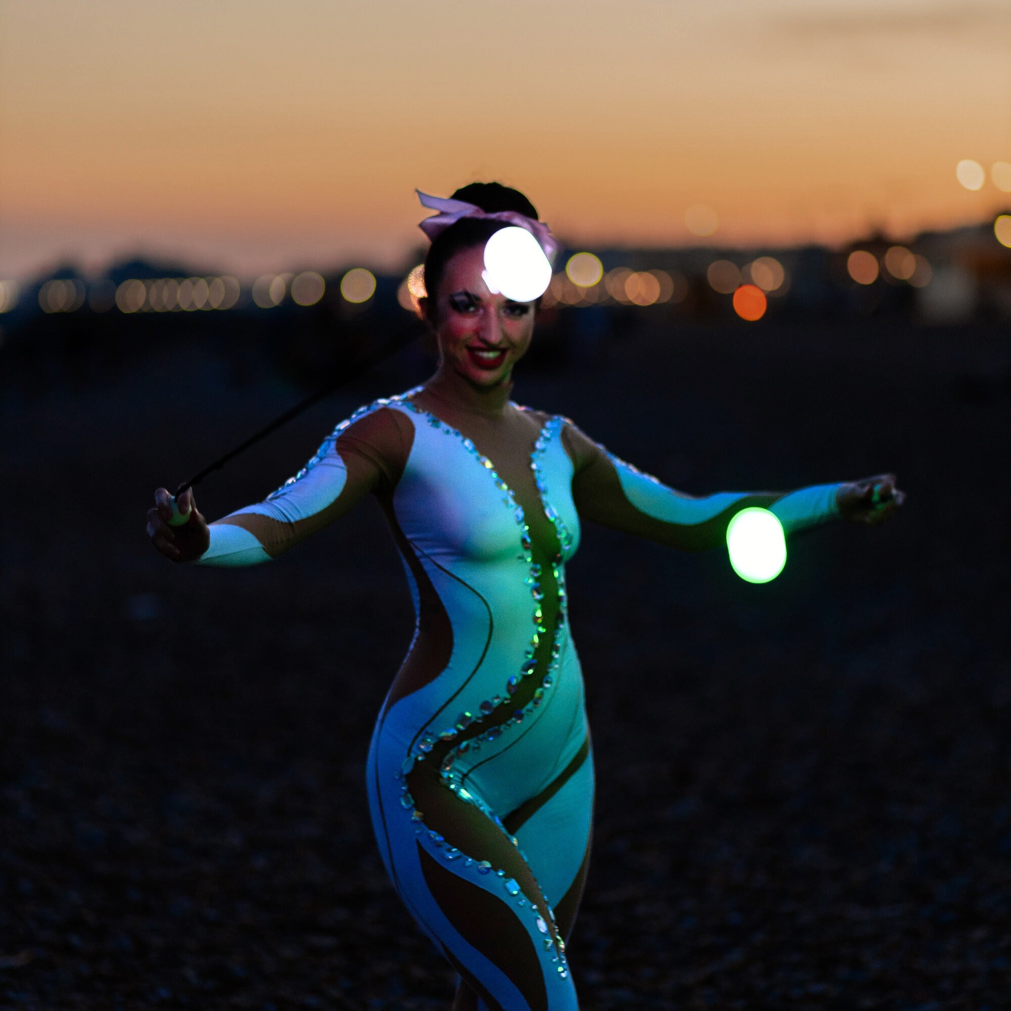 performer illuminated by glow poi