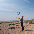 performer with 3 rings on a beach